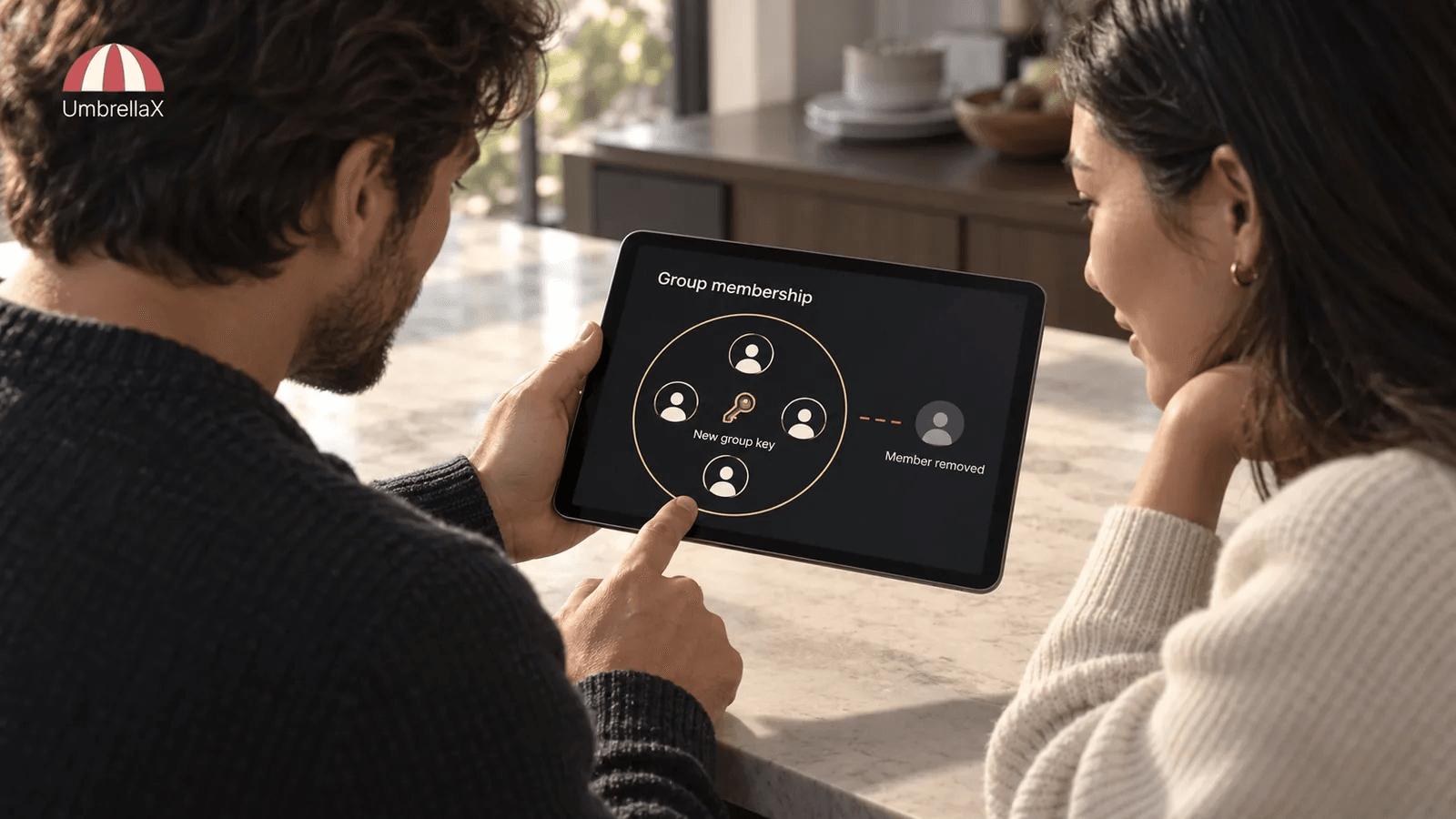 Two people review a removed group member and a new group key on a tablet.