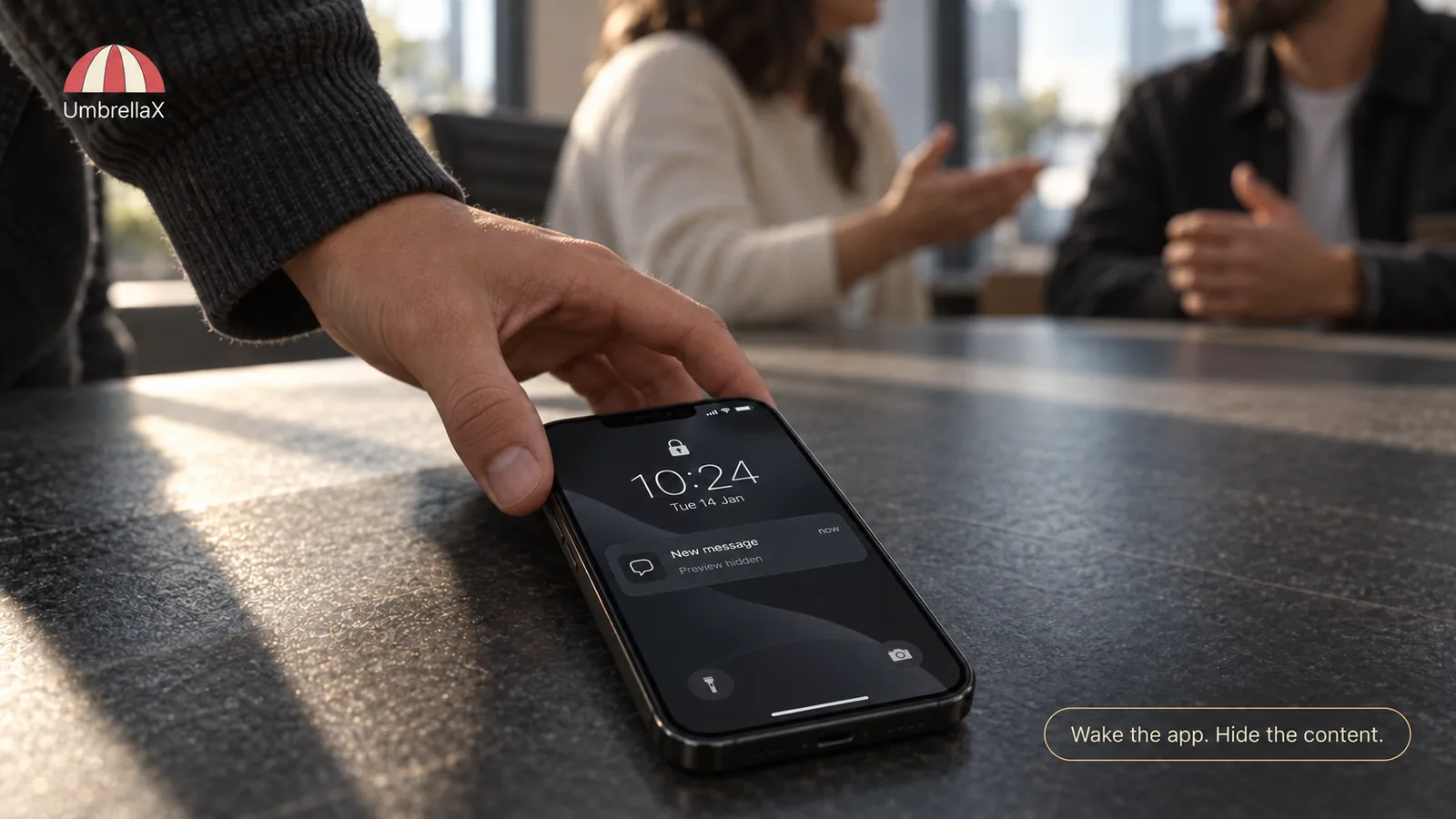 A phone displays a limited lock-screen notification in a shared meeting space.