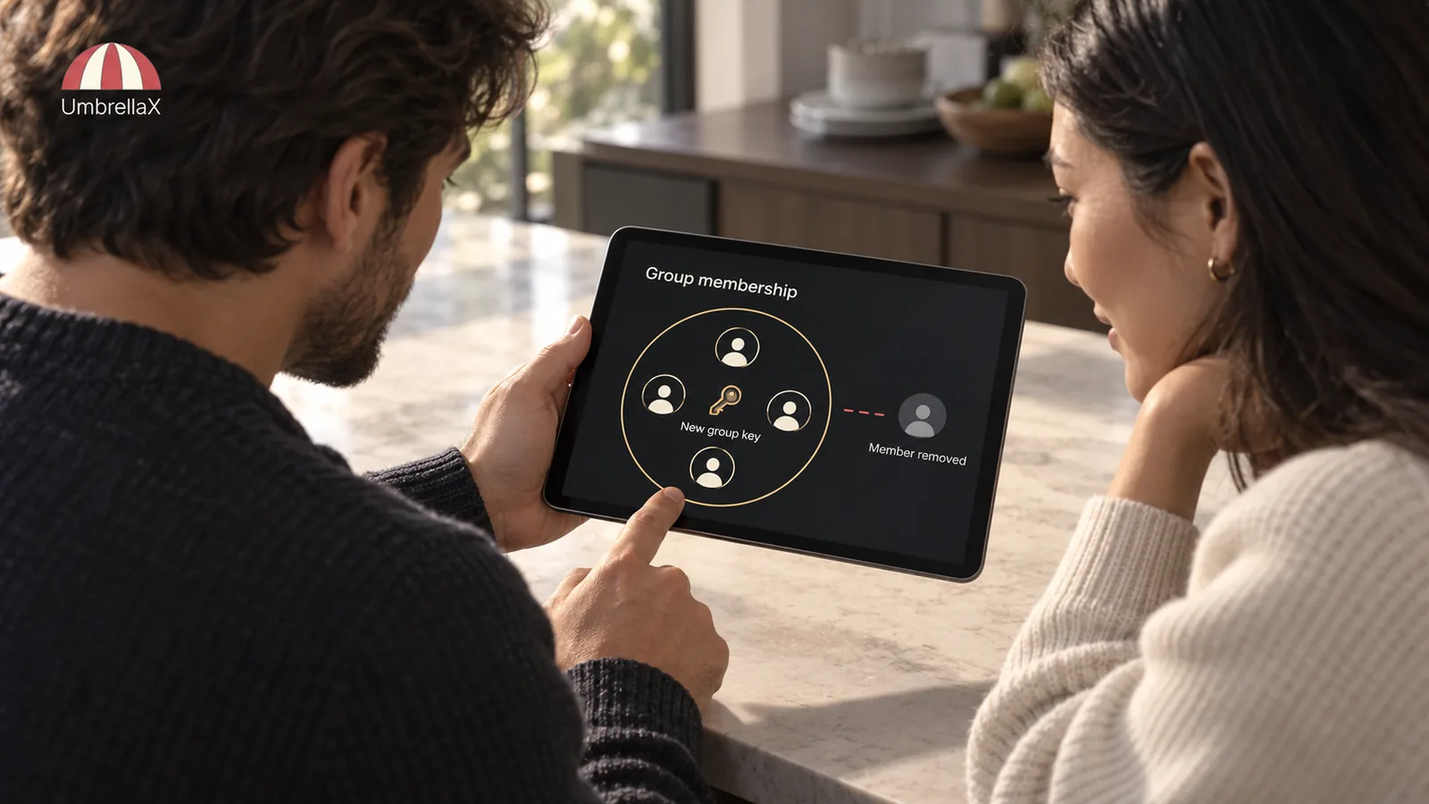 Two people review a removed group member and a new group key on a tablet.