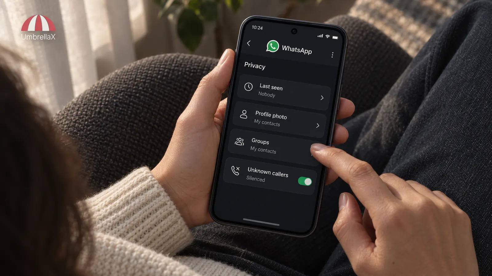 A person adjusts WhatsApp privacy controls at home.